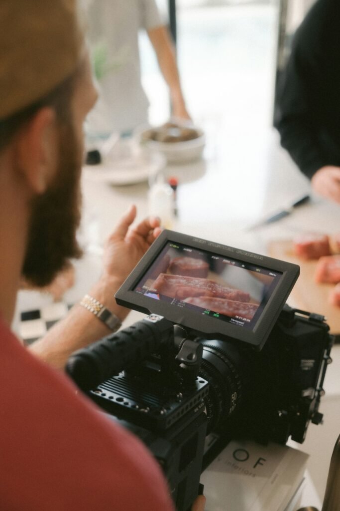 Videographer filming with a camera at an outdoor event