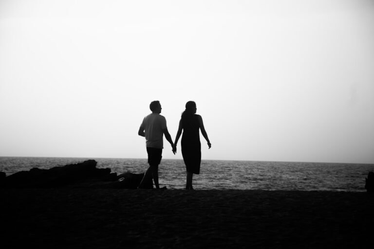 Couple walking hand in hand along the shoreline